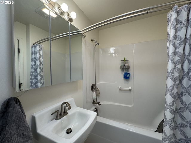 bathroom with sink and shower / tub combo with curtain