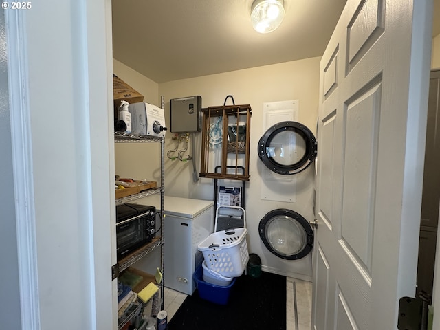 clothes washing area featuring light tile patterned flooring