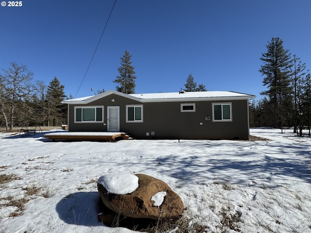 view of snow covered rear of property