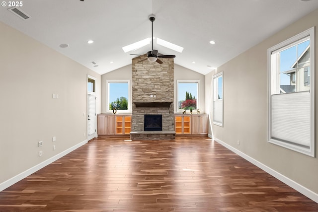 15430 NW Delia St, Portland, OR 97229 - unfurnished living room featuring a skylight, dark wood-type flooring, a stone fireplace, baseboards, and recessed lighting