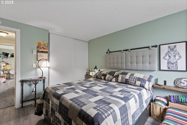 159 SW Florence Ave Unit J53, Gresham, OR 97080 - bedroom with wood finished floors, a closet, and a textured ceiling