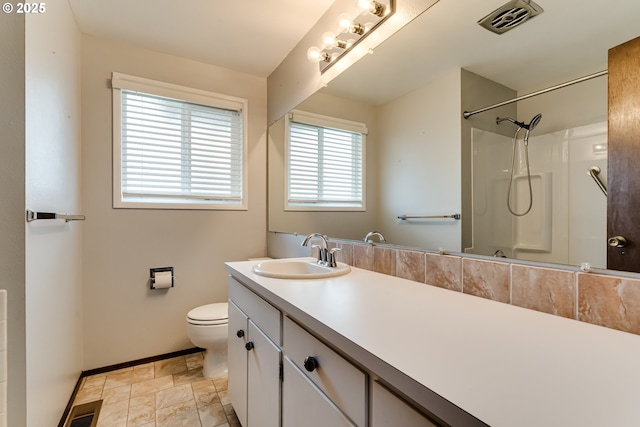 bathroom featuring visible vents, toilet, walk in shower, and vanity