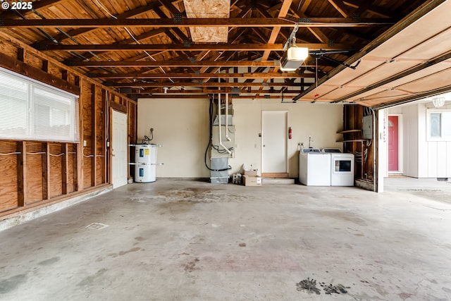 garage with washer and dryer and secured water heater