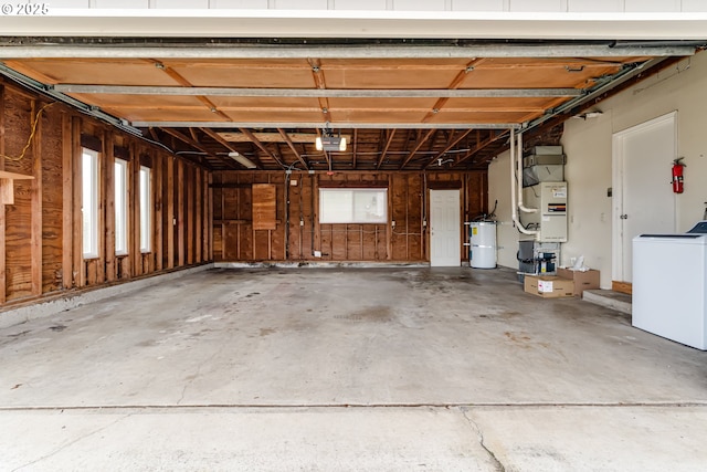 garage featuring washer / dryer, heating unit, and a garage door opener