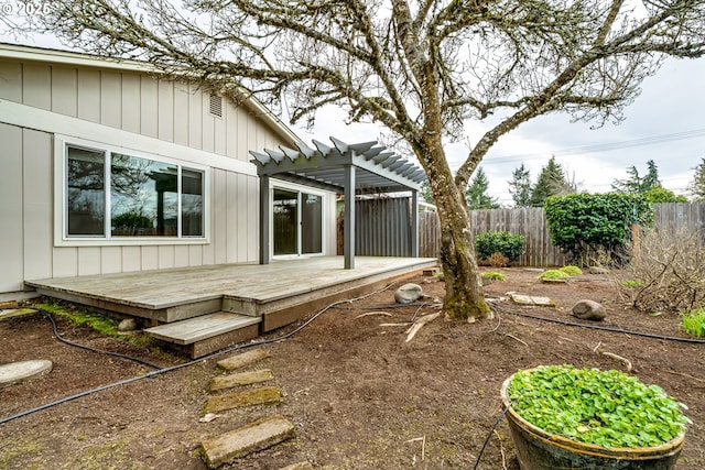 view of yard with a wooden deck, a pergola, and fence