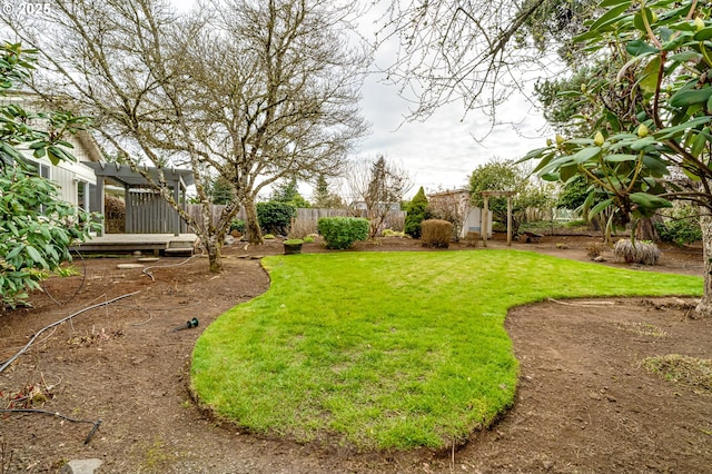 view of yard with fence and a pergola