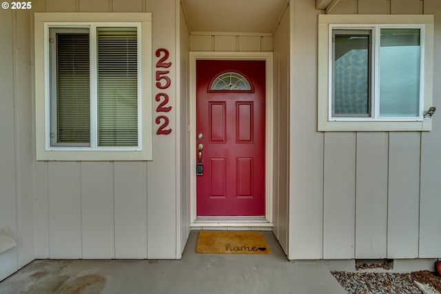 property entrance featuring board and batten siding