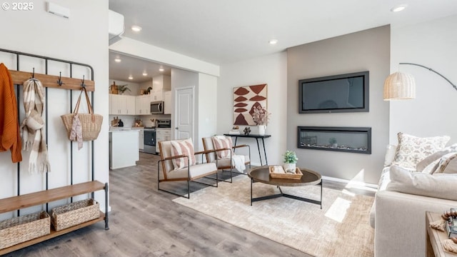 3422 SW Hartley Ave, Gresham, OR 97080 - living area with light wood-style flooring, recessed lighting, and a glass covered fireplace