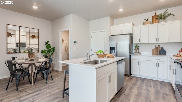 3422 SW Hartley Ave, Gresham, OR 97080 - kitchen with stainless steel appliances, light wood-style flooring, recessed lighting, and white cabinets