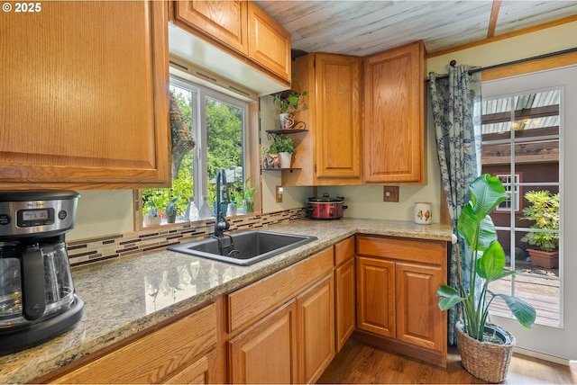 12785 Sutherland Rd, Swisshome, OR 97480 - kitchen featuring a sink, wood finished floors, light stone countertops, and open shelves