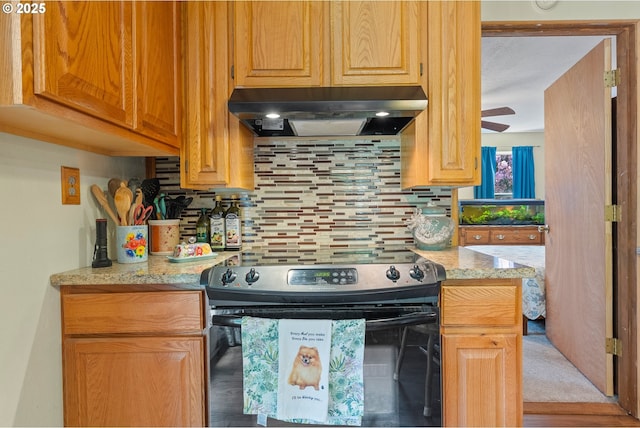 12785 Sutherland Rd, Swisshome, OR 97480 - kitchen with electric range, under cabinet range hood, tasteful backsplash, light stone counters, and ceiling fan