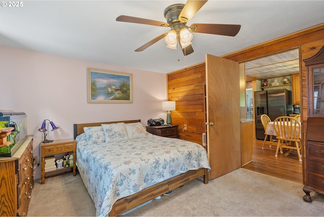12785 Sutherland Rd, Swisshome, OR 97480 - bedroom with stainless steel refrigerator with ice dispenser, carpet, and a ceiling fan