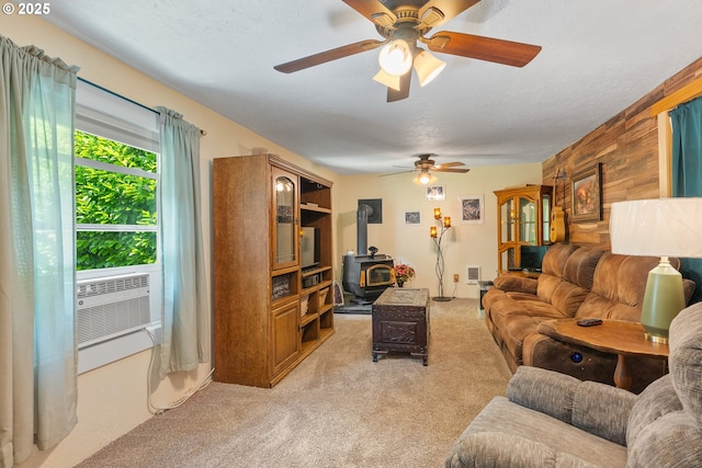 12785 Sutherland Rd, Swisshome, OR 97480 - living area with light colored carpet, a wood stove, a ceiling fan, and cooling unit