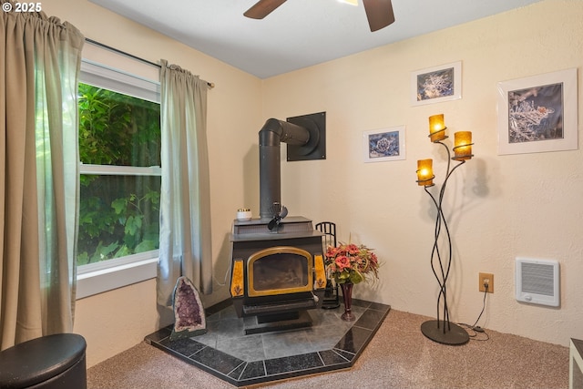 12785 Sutherland Rd, Swisshome, OR 97480 - detailed view of a wood stove, ceiling fan, heating unit, and a textured wall