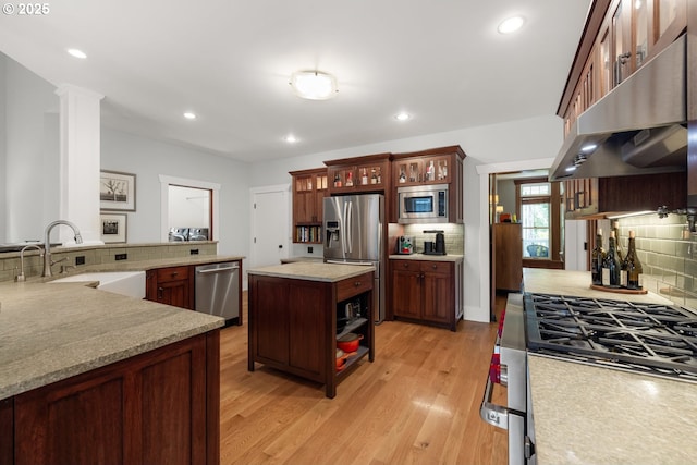 12624 SW 22nd Ave, Lake Oswego, OR 97034 - kitchen featuring appliances with stainless steel finishes, extractor fan, decorative backsplash, light wood-style floors, and recessed lighting