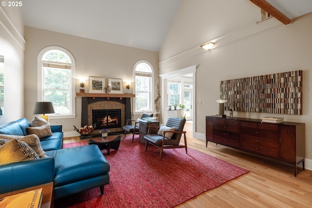 12624 SW 22nd Ave, Lake Oswego, OR 97034 - living area with wood finished floors, healthy amount of natural light, high vaulted ceiling, and a tile fireplace