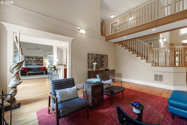 12624 SW 22nd Ave, Lake Oswego, OR 97034 - living area featuring stairway, wood finished floors, ceiling fan, and a high ceiling