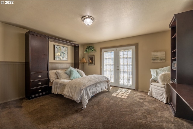 carpeted bedroom featuring french doors, a textured ceiling, and access to outside