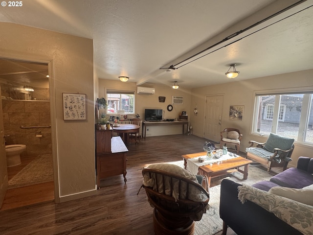 living room featuring dark wood-type flooring and an AC wall unit