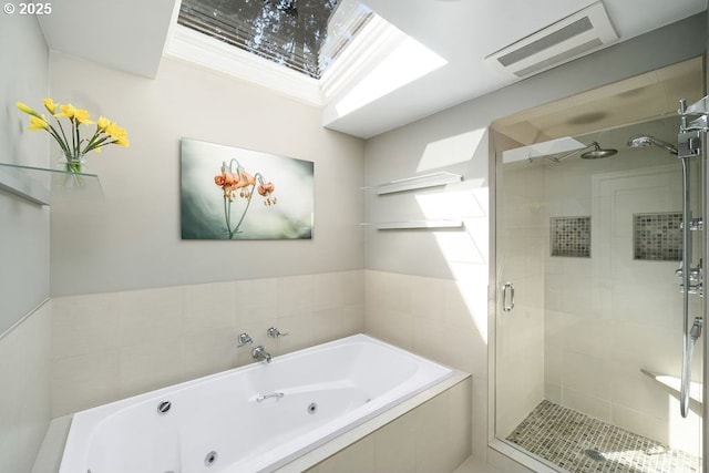 bathroom with a shower stall, visible vents, and a jetted tub
