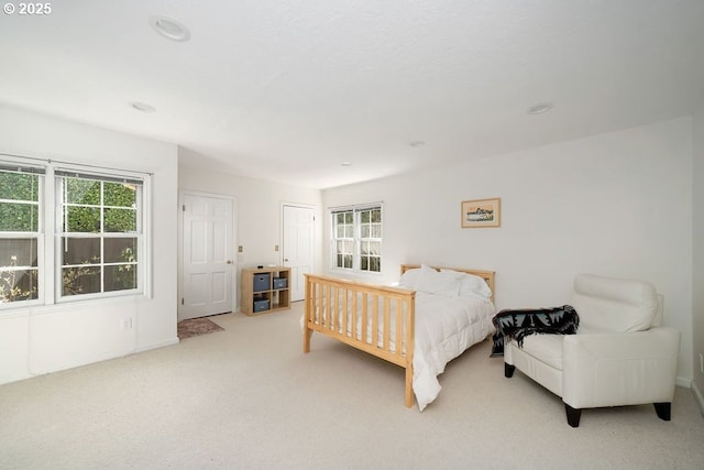 carpeted bedroom with baseboards and multiple windows