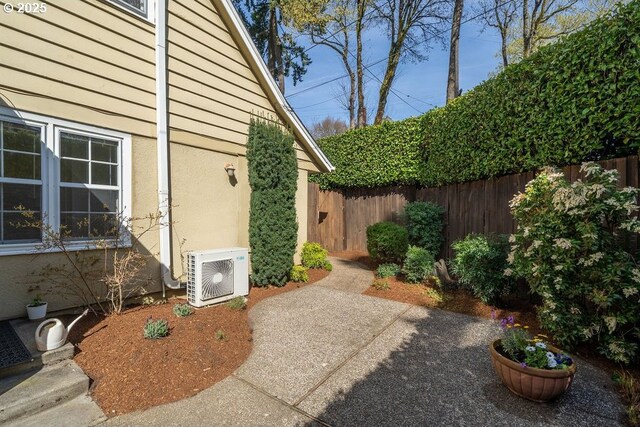 exterior space featuring fence and ac unit