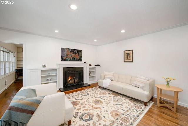 living room featuring recessed lighting, wood finished floors, and baseboards