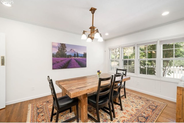 dining area featuring recessed lighting, a wealth of natural light, a chandelier, and ornamental molding