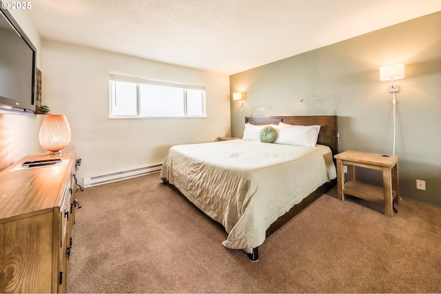 bedroom with a baseboard heating unit and carpet flooring