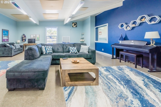carpeted living area featuring beamed ceiling and baseboards