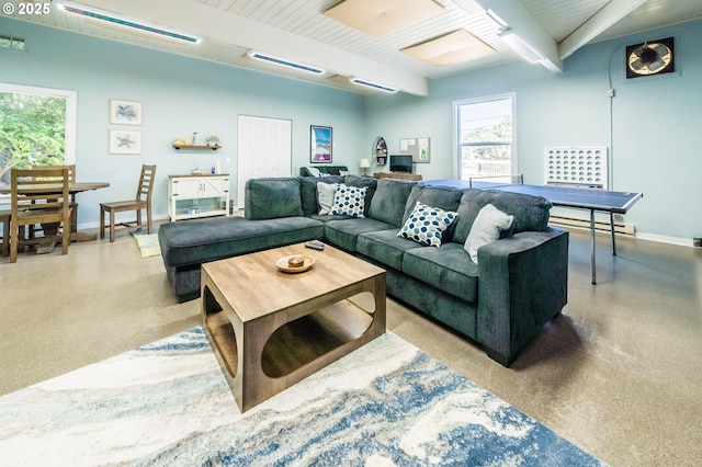 living area with beamed ceiling, speckle patterned floor, and baseboards