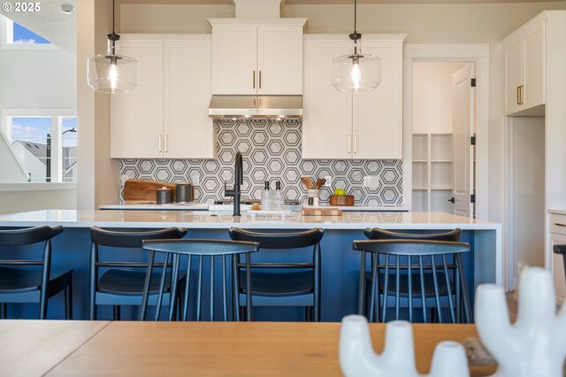 15174 SW 164th Ave Unit L12, Tigard, OR 97224 - kitchen featuring range hood, light countertops, backsplash, and white cabinets