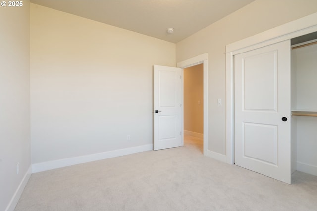 15174 SW 164th Ave Unit L12, Tigard, OR 97224 - unfurnished bedroom featuring light carpet, a closet, and baseboards