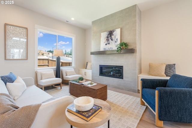 15174 SW 164th Ave Unit L12, Tigard, OR 97224 - living area featuring light wood finished floors, a tiled fireplace, and recessed lighting
