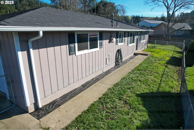 view of side of home with a yard