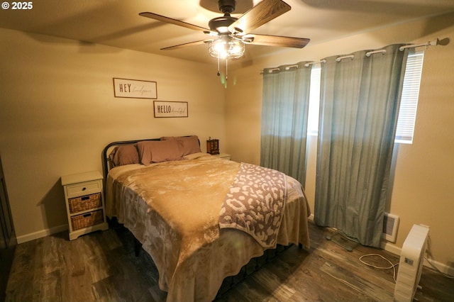 bedroom with ceiling fan and dark hardwood / wood-style floors