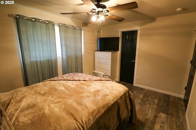 bedroom with ceiling fan and dark hardwood / wood-style floors