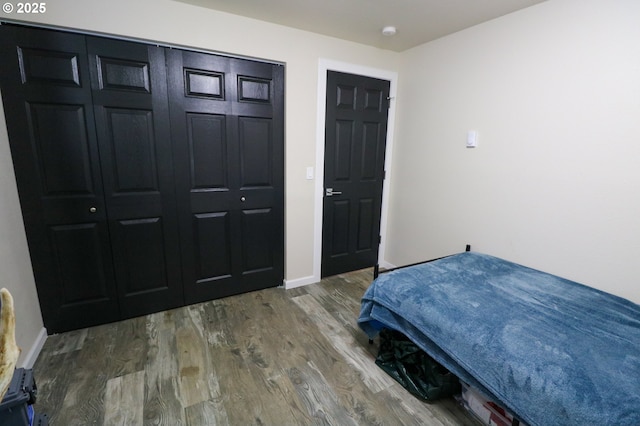 bedroom with hardwood / wood-style floors and a closet