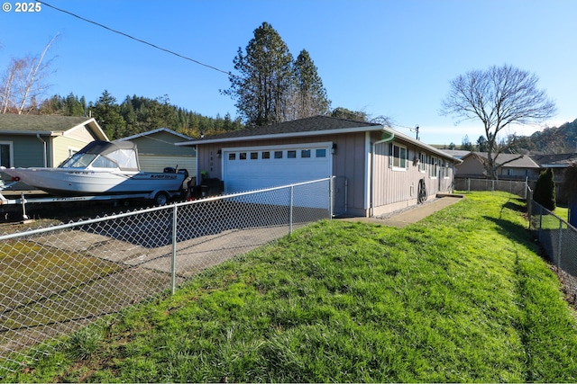 view of home's exterior featuring a garage and a yard