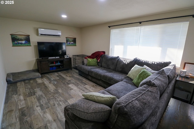 living room with a wall unit AC and hardwood / wood-style flooring