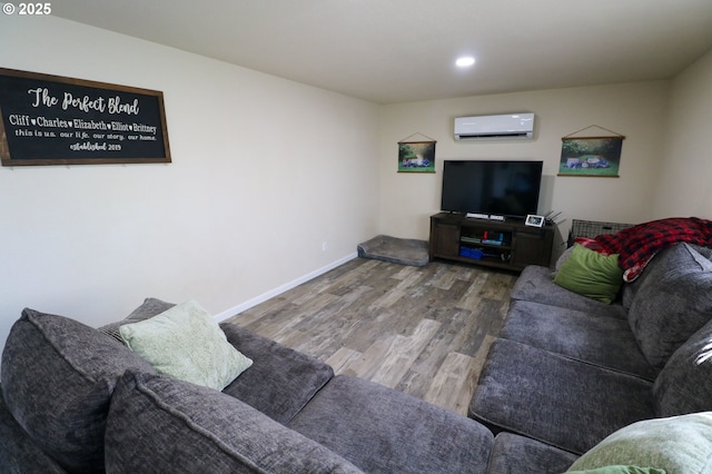 living room with hardwood / wood-style flooring and a wall mounted air conditioner