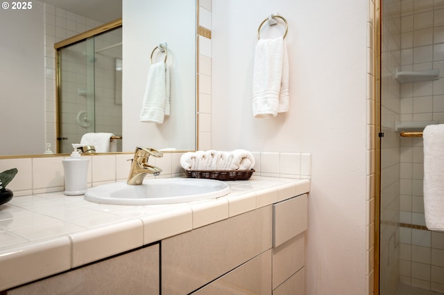 bathroom with a stall shower and vanity