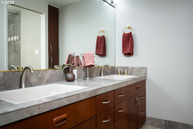 bathroom featuring a sink and double vanity