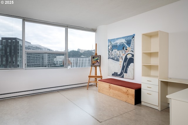 interior space featuring finished concrete flooring, a view of city, baseboard heating, and a textured ceiling