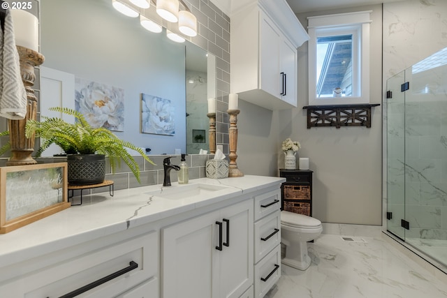 bathroom featuring toilet, vanity, and walk in shower