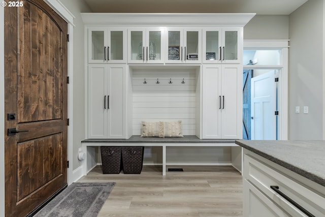 mudroom with light hardwood / wood-style floors