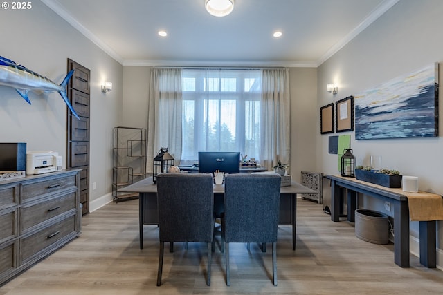 dining area with light hardwood / wood-style floors and ornamental molding