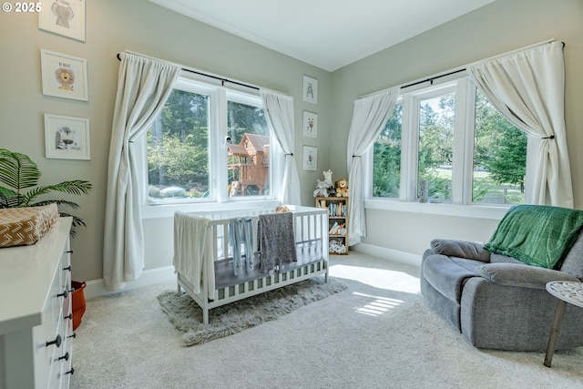 carpeted bedroom with a nursery area