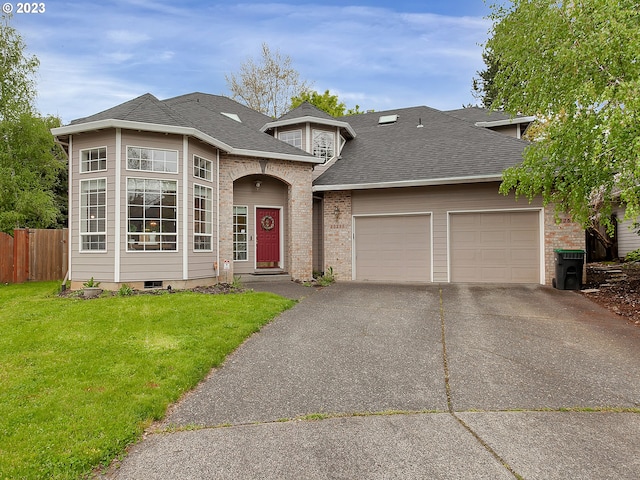 view of front facade with a garage and a front lawn