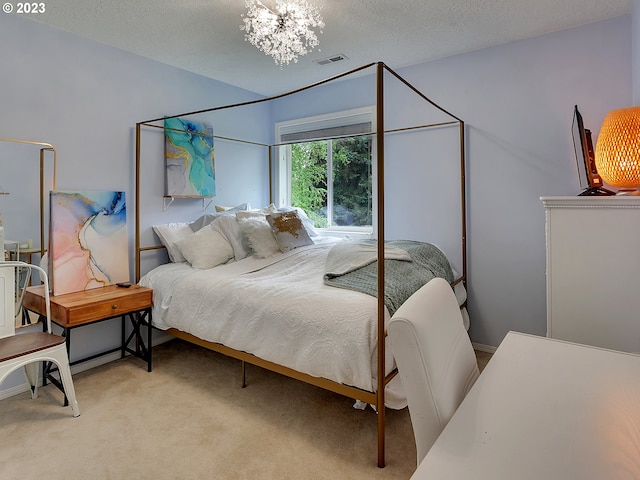 bedroom with light colored carpet, a textured ceiling, and an inviting chandelier